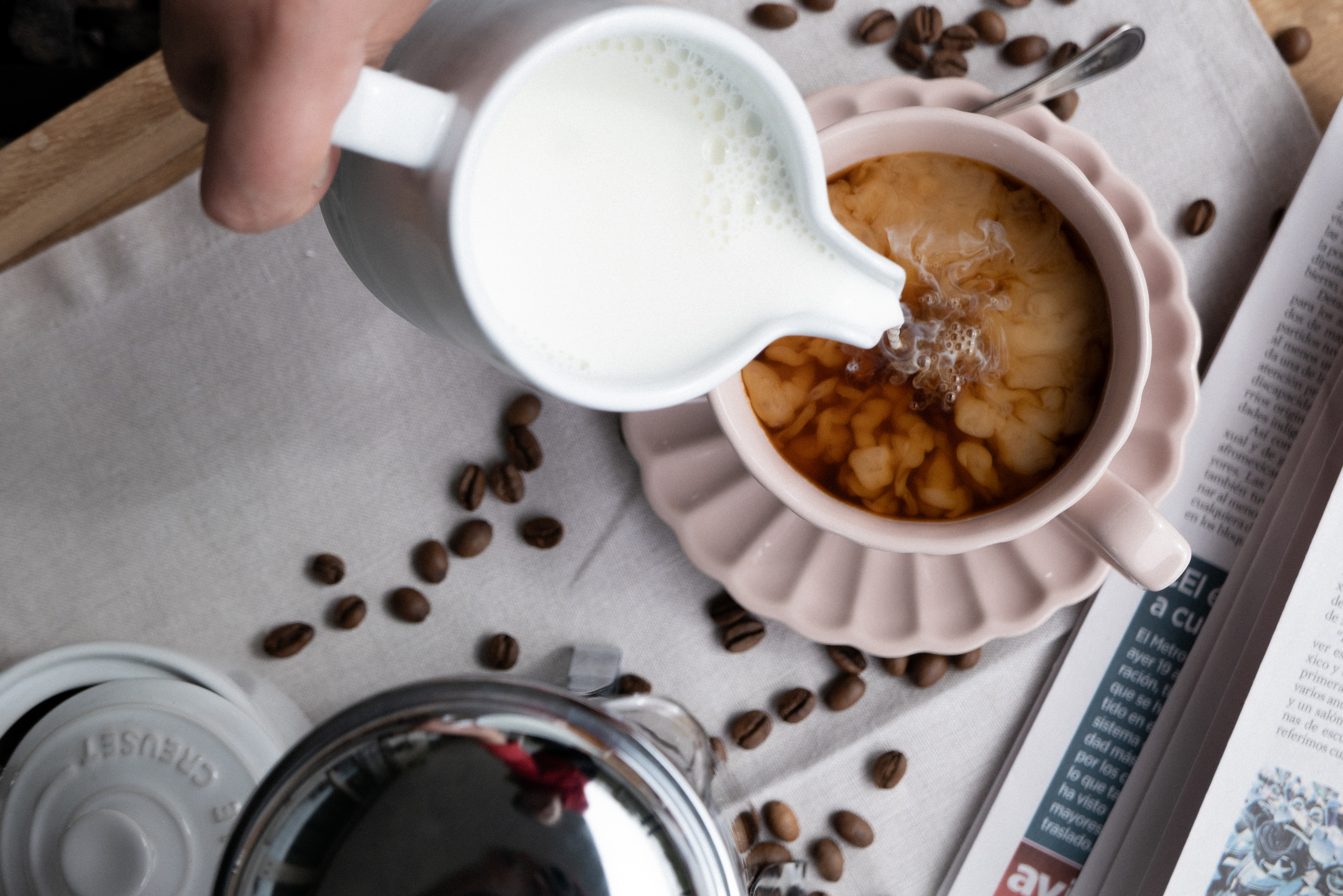 Pouring milk into coffee